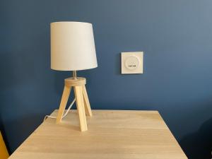 a lamp sitting on top of a table at Maison a 3 minutes de soissons in Soissons