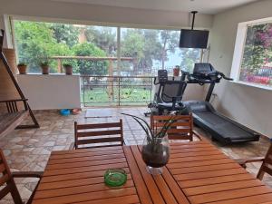 a living room with a table and a view of a balcony at Kouros Studios in Kavála