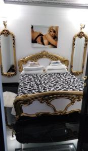 a bedroom with a bed with a picture of a woman at Отель Jolly in Cahul +3 photos