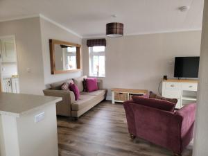 a living room with a couch and two chairs at Luxury 2-Bed Lodge in Routh Sleeps 4 with Hot Tub in Beverley