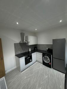 a kitchen with a washer and dryer in it at Luxury 2 Bed Apartment, Sleeps 6 with Sofa bed, Close to Sale Tram Station in Sale