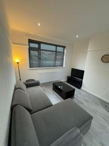 a living room with a couch and a tv at Luxury 2 Bed Apartment, Sleeps 6 with Sofa bed, Close to Sale Tram Station in Sale +24 photos