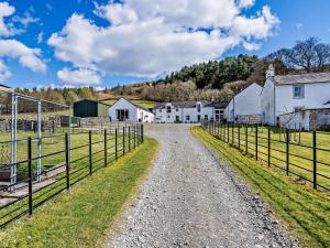 a dirt road through a farm with houses and fences at 4 bed property in Moffat 82374 in Moffat