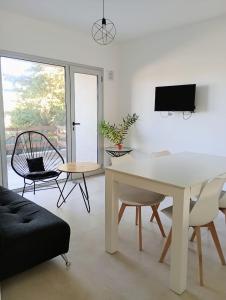 a living room with a white table and chairs at Village de Mar in Monte Hermoso