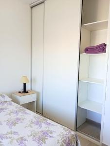 a bedroom with a large mirror next to a bed at Village de Mar in Monte Hermoso
