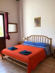 a bedroom with a bed with two towels on it at Punta del Cane in Fontane Bianche