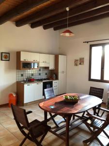 a kitchen and dining room with a table and chairs at Punta del Cane in Fontane Bianche +30 photos
