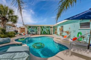 a swimming pool in the backyard of a house at Walk to Beach, Heated Pool, Dog-Friendly, Firepit in Daytona Beach