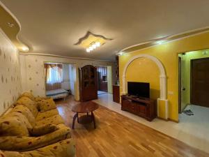 a living room with a couch and a tv at Jermuk in Jermuk