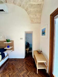 a living room with a table and a room at Tangram Ostuni Apartment in Ostuni