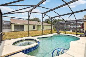 a swimming pool with a clear glass roof over it at Villa Del Sol in Davenport
