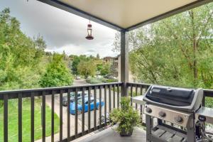 a grill on a balcony with a view of a street at River Pines C207 condo in Edwards