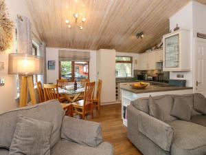 ウィンダミアにあるFootprints Lodgeのリビングルーム(ソファ2台付)、キッチンが備わります。