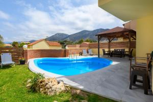 a swimming pool in the backyard of a house at Renia's Villas in Hersonissos