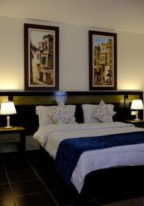 a bedroom with two beds with paintings on the wall at Viking club hotel in Sharm El Sheikh