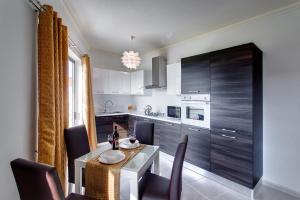 a kitchen with a table and chairs and a dining room at Cozy Apartment in St Paul's Bay in St Paul's Bay