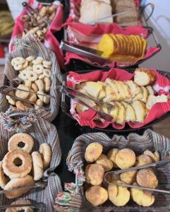 um monte de diferentes tipos de pão e doces em Hospedagem Platô em Monte Verde
