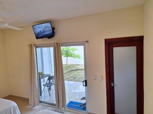 a room with a tv on the wall and a door at Hotel La Guarida in Palma