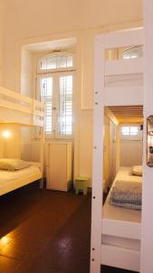 a room with two bunk beds and a window at Agüita House in Las Palmas de Gran Canaria