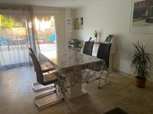 a dining room with a table and some chairs at L échappée belle in Vallon-Pont-dʼArc