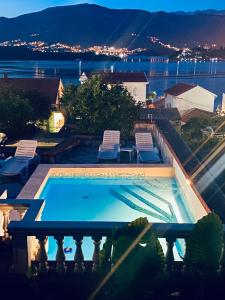 a swimming pool on a balcony with a view of the water at INO Apartments in Tivat