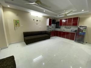 a living room with a couch and a kitchen at Viator in Jhelum