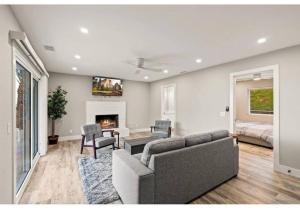 a living room with a couch and a fireplace at Hidden Oasis Near Safari - Wineries - Lakes in Escondido
