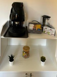 a coffee maker sitting on top of a shelf at Relax House - vicino al centro, lontano dal caos in Casalnuovo di Napoli