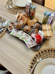 a table with a tray of breakfast food on it at Relax House - vicino al centro, lontano dal caos in Casalnuovo di Napoli