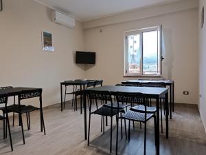 a room with tables and chairs and a window at Il Quadrifoglio in Frascineto