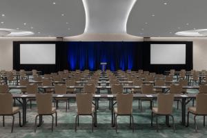a conference room with tables and chairs and a podium at The Westin Atlanta Gwinnett in Duluth