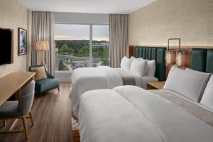 a hotel room with two beds and a window at The Westin Atlanta Gwinnett in Duluth
