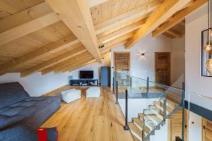 a living room with wooden ceilings and a glass staircase at Chalet Alpea - 8 personnes in Châtel