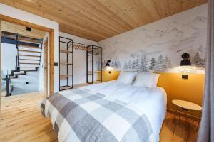 a bedroom with a large bed and a staircase at Chalet Alpea - 8 personnes in Châtel