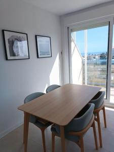 a wooden table and chairs in a room with a window at Beach,s House in Playa del Puig in La Torre