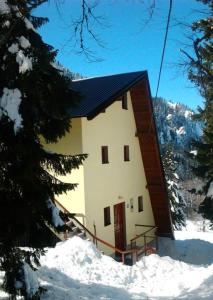 a small building in the snow with snow at Apartments Milinkovic in Jahorina