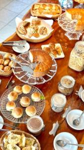 a table topped with plates of bread and pastries at Kastel Jampa Hotel in João Pessoa
