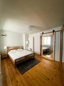 a bedroom with a bed and a large mirror at Dome square apartment, Old Town in Riga