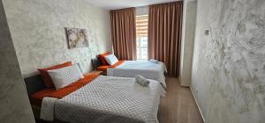a hotel room with two beds and a window at Luxury apartment near TGV station and the beach in Tangier