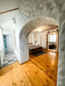 a room with a stone archway with a bed in it at Dome square apartment, Old Town in Riga