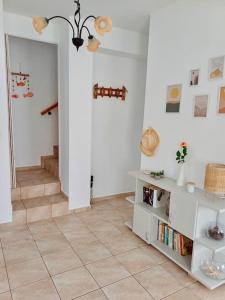 a living room with a staircase and a book shelf at Amorgos Aegean Heaven in Amorgos
