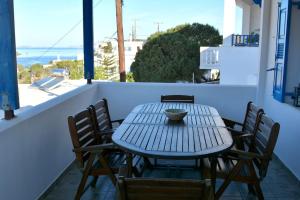 a table and chairs on a balcony with a view of the ocean at Amorgos Aegean Heaven in Amorgos