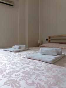 2 camas con toallas encima en una habitación en Il Quadrifoglio, en Frascineto