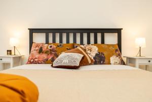 a bedroom with a bed with pillows and avertisement at Nonna ADELINA a 150 m da Cala Moresca in Àrbatax