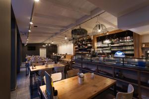 a restaurant with tables and chairs and a bar at Haus Wilkens in Kerpen