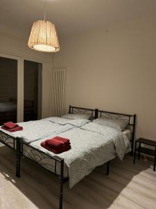 a bedroom with a bed with two red towels on it at Lavanda House in Vicenza