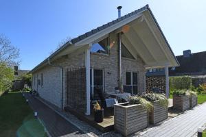 a brick house with awning on the side of it at Ferienhaus in Schlagsdorf auf Fehmarn in Schlagsdorf