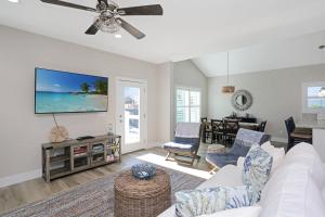 a living room with a white couch and a tv at Second Chance by Pristine Properties Vacation Rentals in Mexico Beach