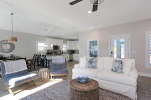 a living room with a white couch and chairs at Second Chance by Pristine Properties Vacation Rentals in Mexico Beach