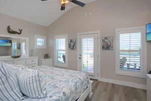 a bedroom with a bed and a sink and windows at Second Chance by Pristine Properties Vacation Rentals in Mexico Beach